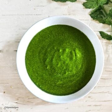 coriander mint chutney in a white serving bowl.