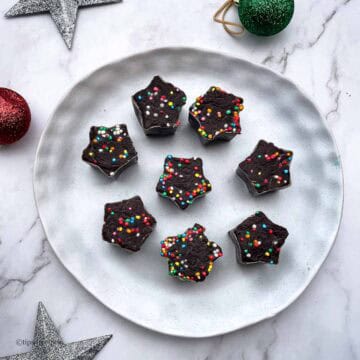 Decorated holiday star cookieschocolate fudge with colourful sprinkles for festive treat.