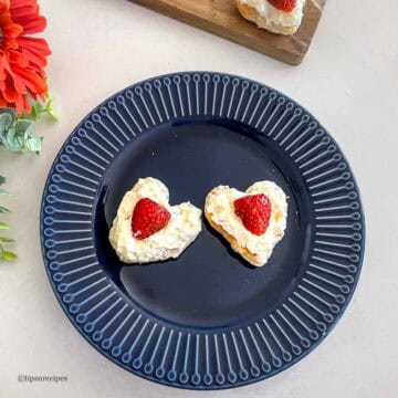 Delicious heart-shaped puff pastry strawberry desserts with whipped cream, perfect for Valentine's Day.