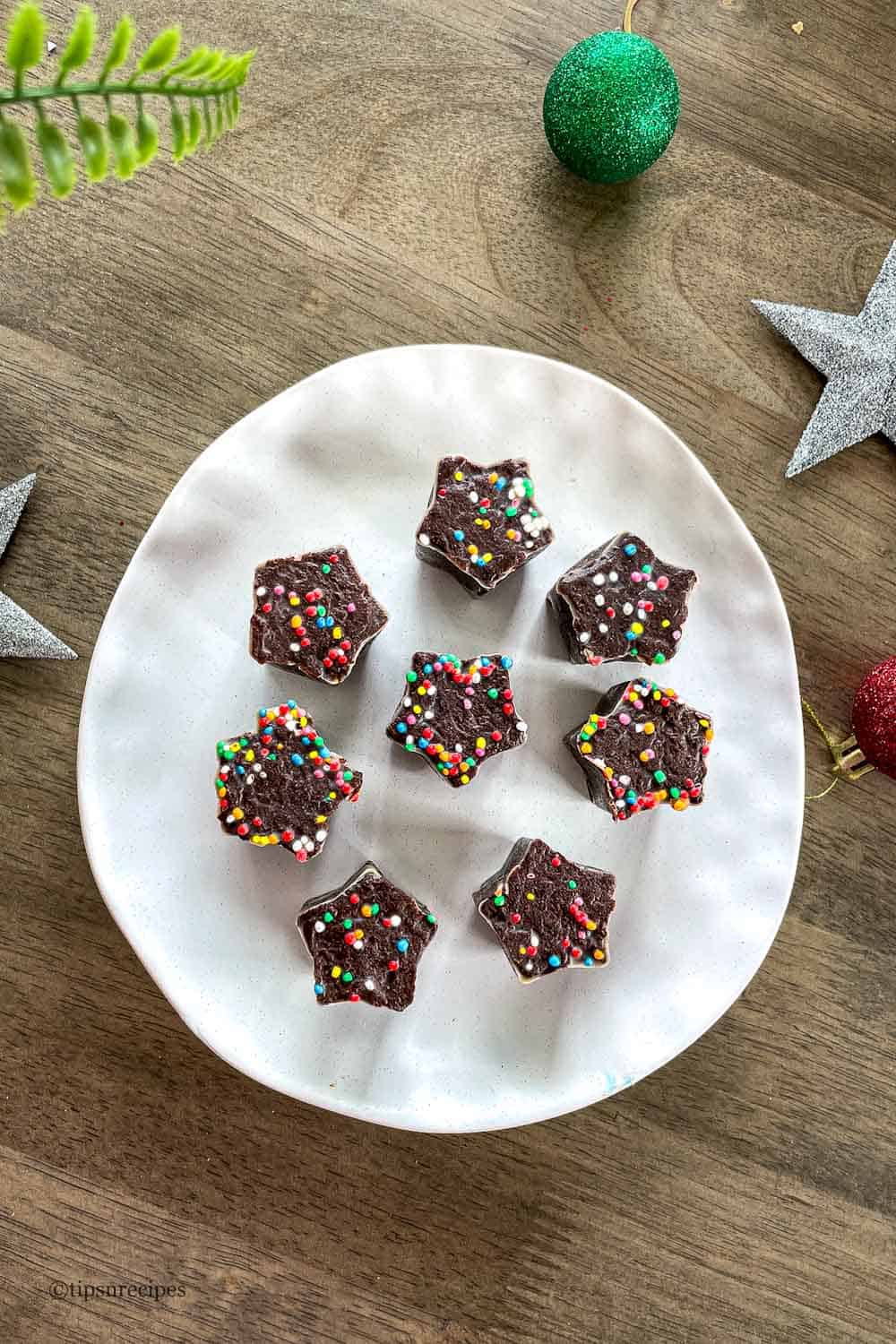 Cholate fudge star shaped dessert on a white plate.