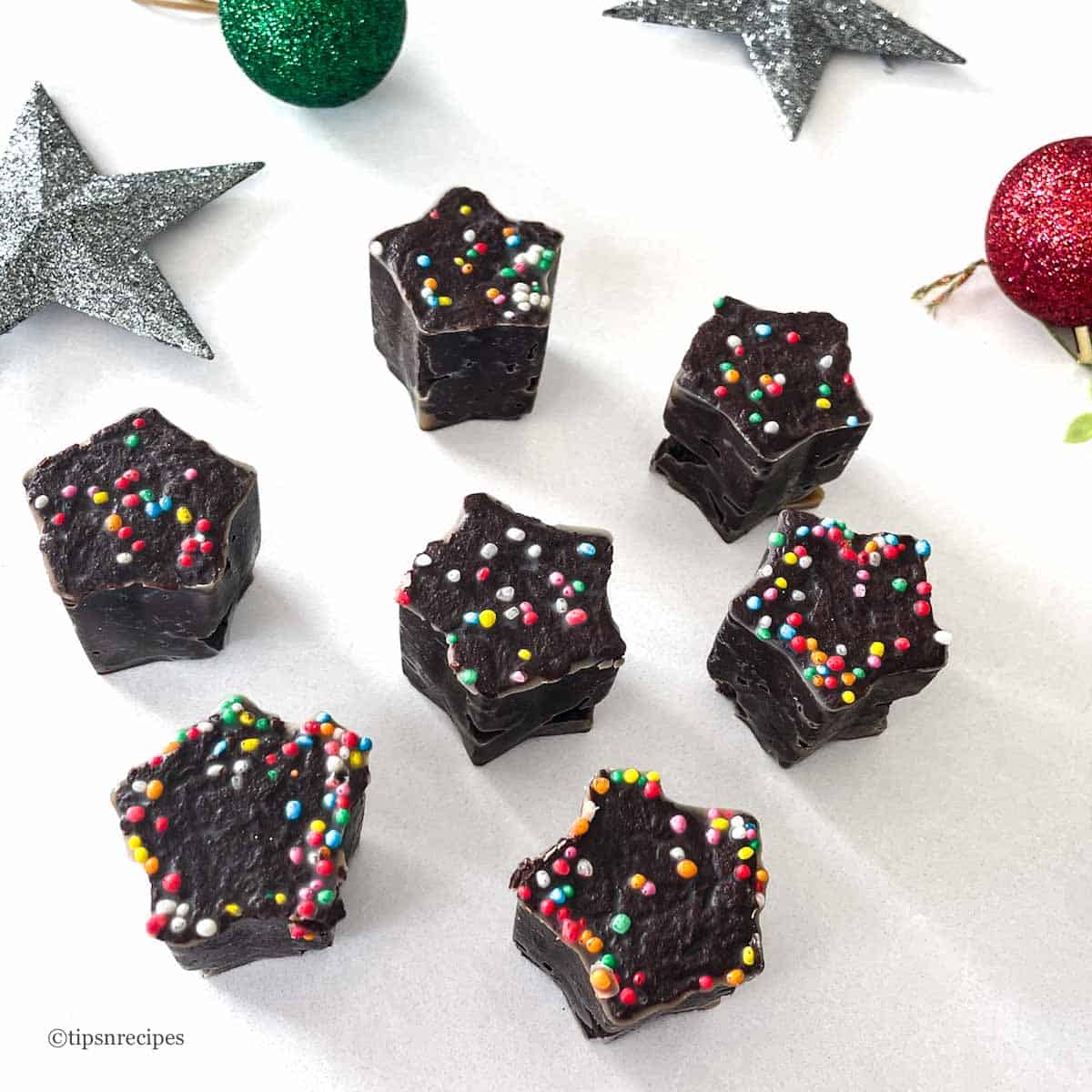 Chocolate fudge with colourful sprinkles on a white background, perfect for festive desserts and holiday celebrations.