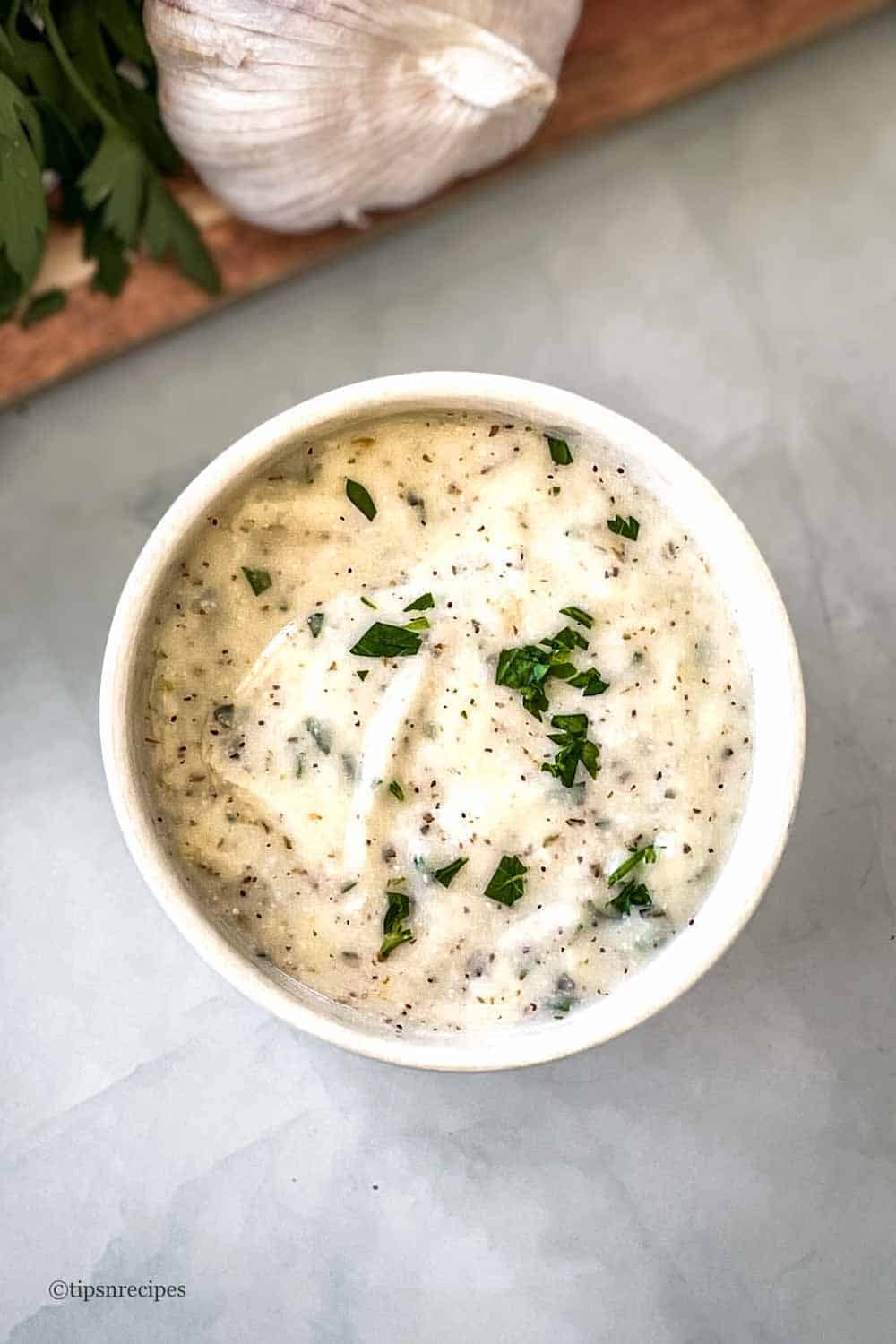 A bowl of gralic dip.
