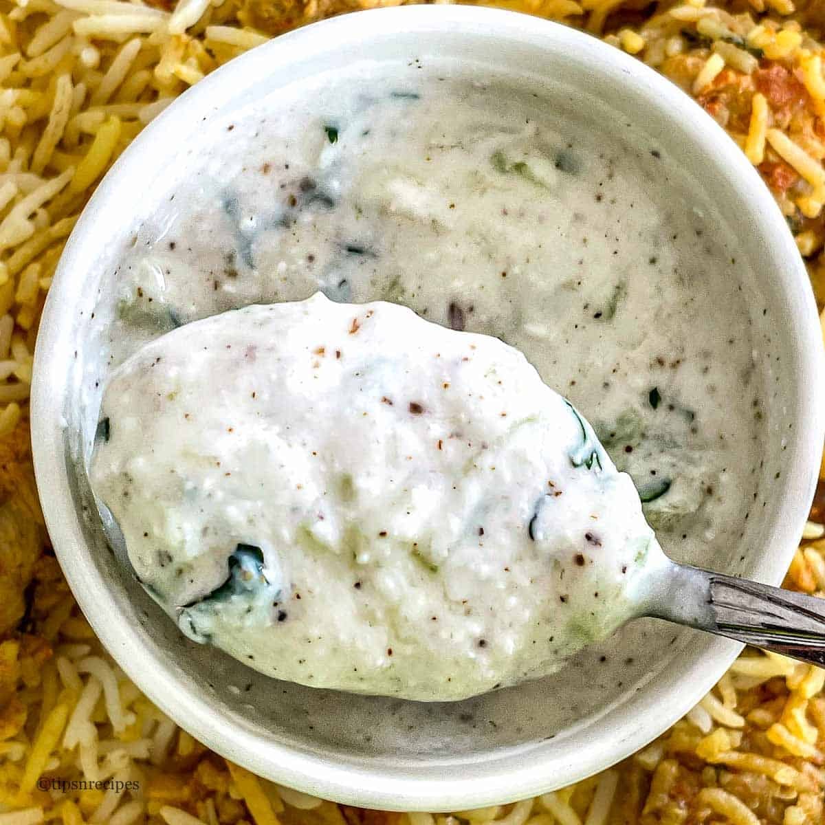 Creamy cucumber served with spiced rice, fresh herbs, and spices.