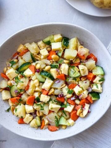 A bowl of boiled potato with cottage cheese salad.