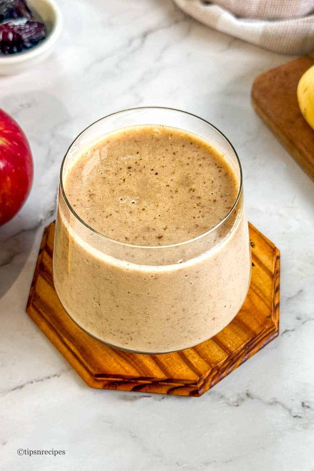 A glass iof refreshing apple banana dates smoothie.