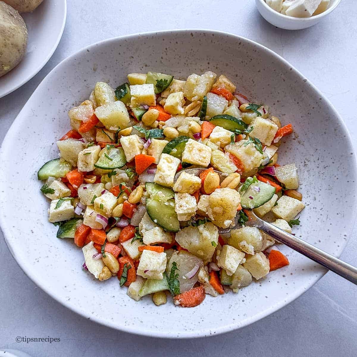 A bowl of healty potato salad with cottage cheese.
