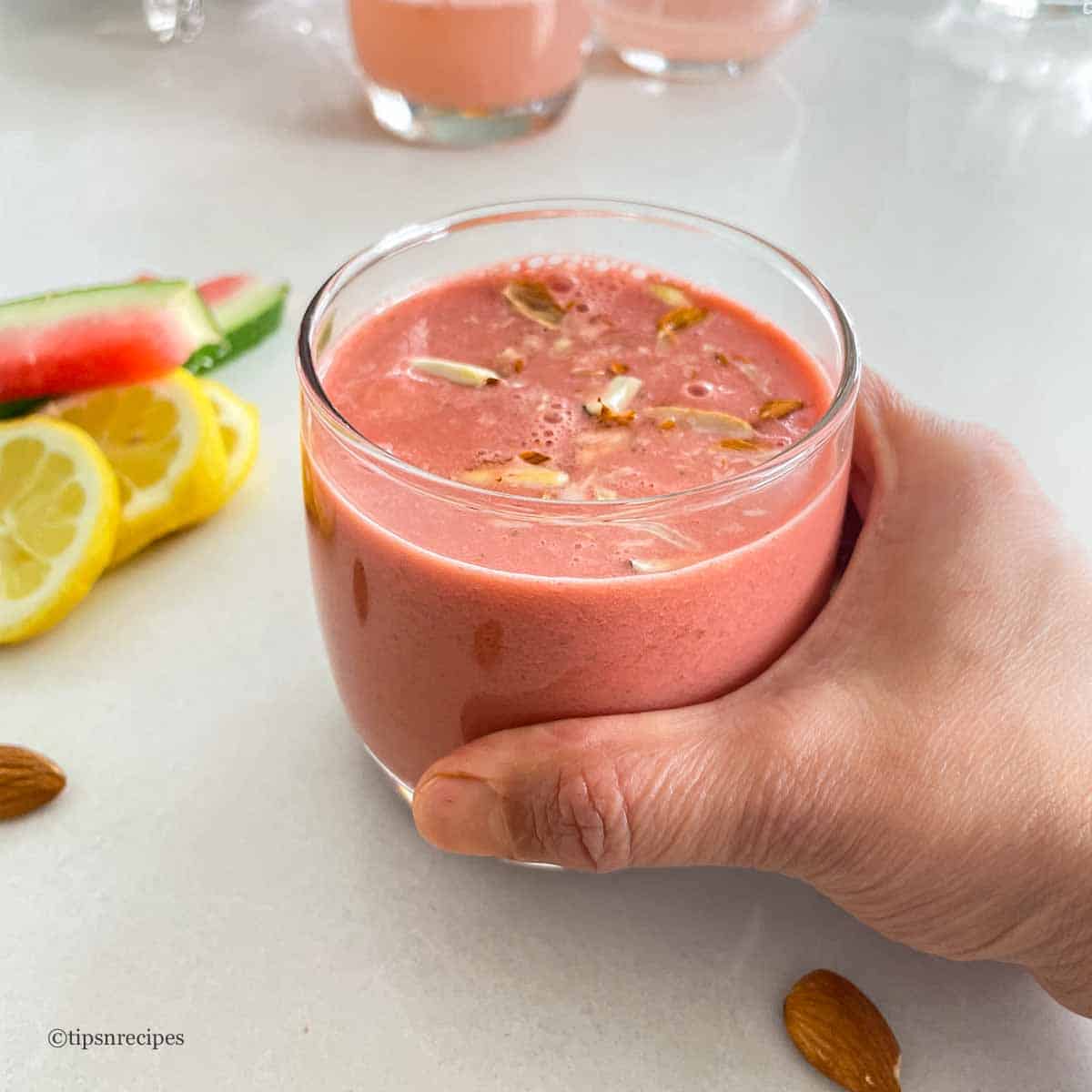 Holding a glass of weight loss smoothie.