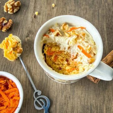 Delicious carrot cake mug cake along with carrots, walnuts and cinnamon.