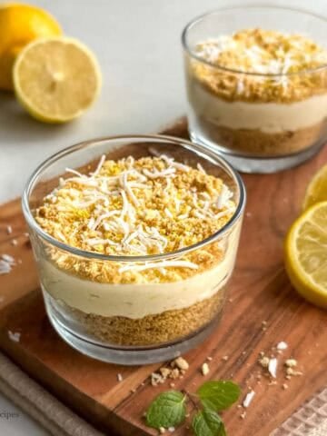 No-bake lemon coconut bliss cups with creamy lemon filling, coconut topping and biscuit base.