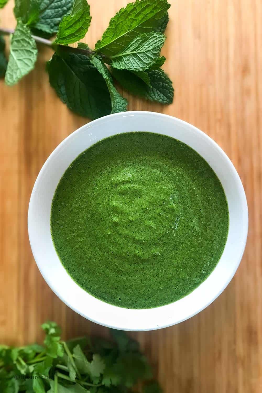 A bowl of refreshing green coriander mint chutney.
