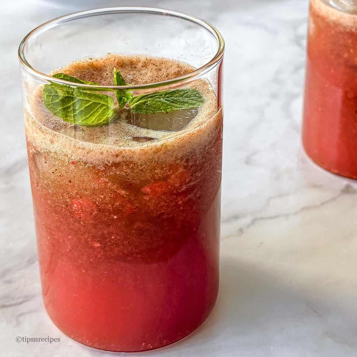 Beautiful glasses of red strawbeery and mint cooler.