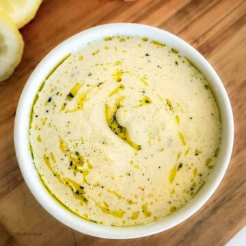 A bowl of high-protein hummus served with veggies.