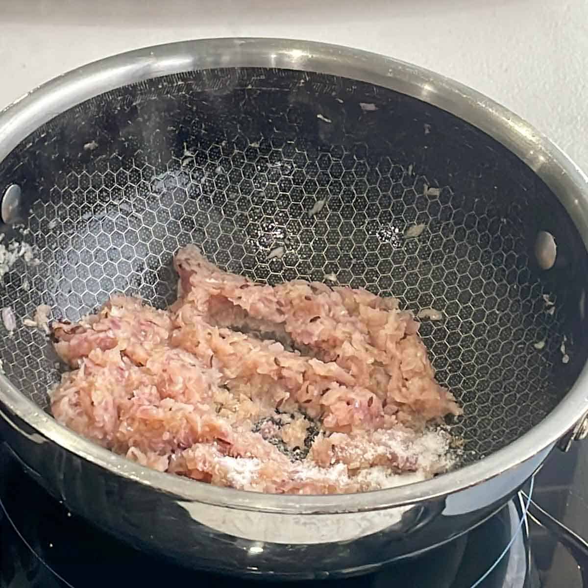 Fried onions for curry base in a skillet.