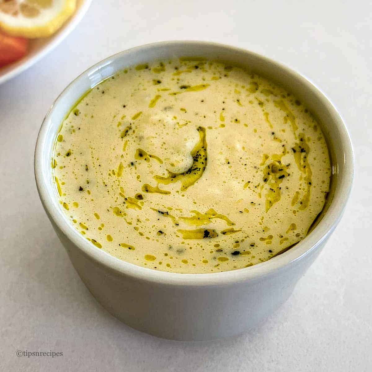 A refreshing bowl of galic and mint falvored hummus.
