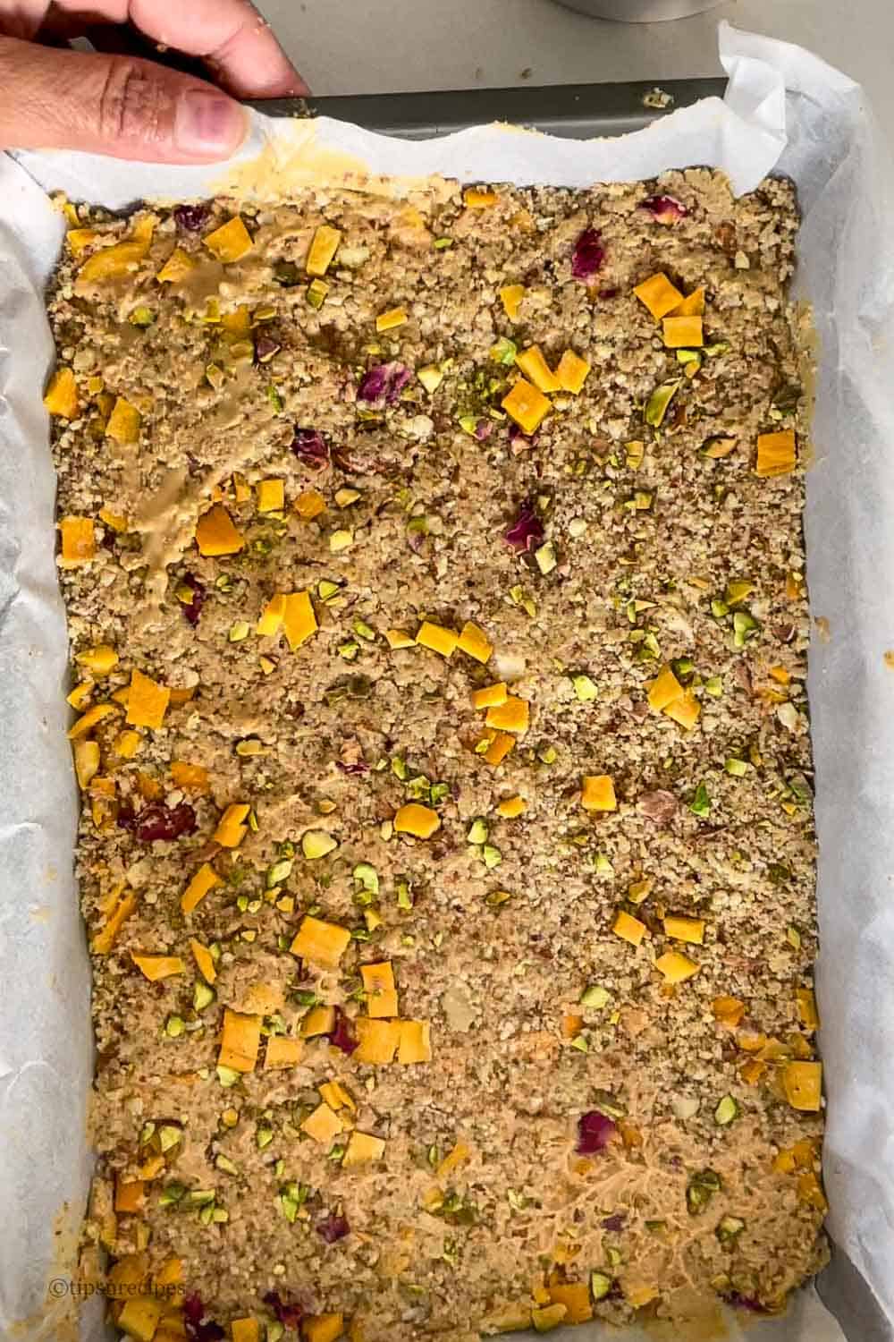 Setting of dried mango and nuts in a dish.