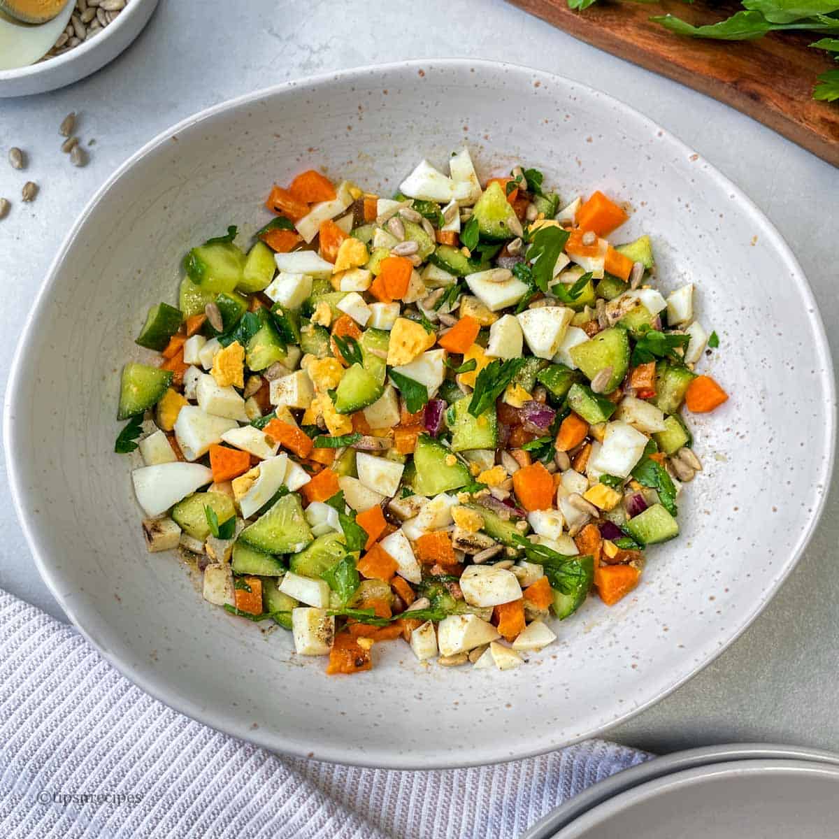 A bowl of fresh vegetables and egg sandwich.