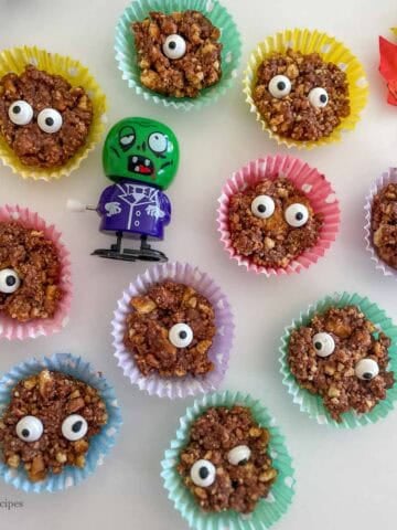 Cute monsters placed in colorful liners for fun Halloween party.