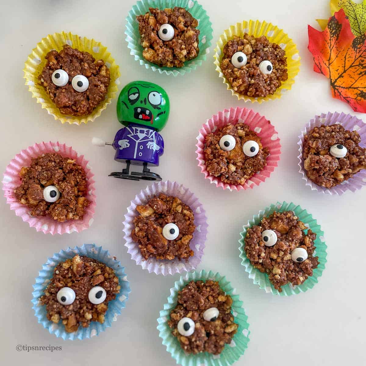 Cute monsters placed in colorful liners for fun Halloween party.