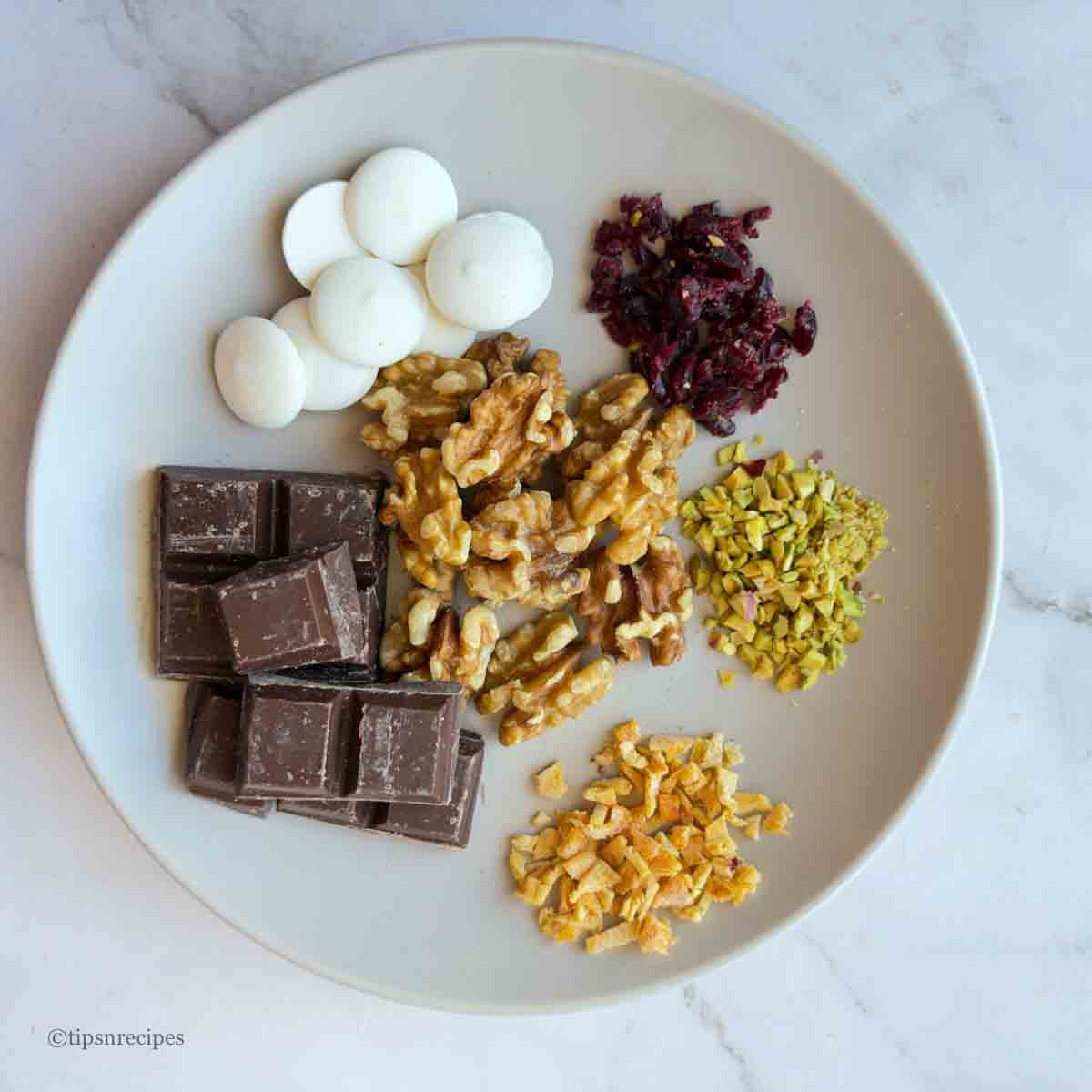 Ingredients for chocolate mini bites prepared with walnuts and dried fruits.