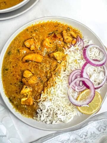 Spicy North Indian chicken curry served with rice and salad.