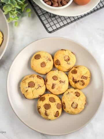 A plate of freshly baked chocolate cookies arranged in circular motion.