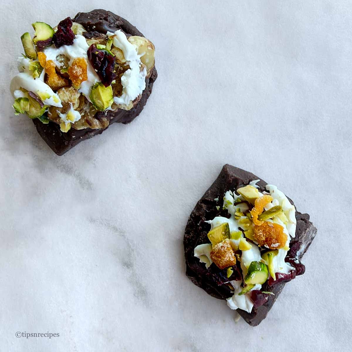 Mini chocolate bites with walnuts and chopped dried fruits showing the textures.
