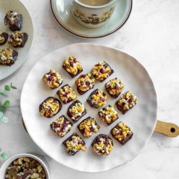 mini chocolate bites with walnuts and dried fruits served with a cup of tea.