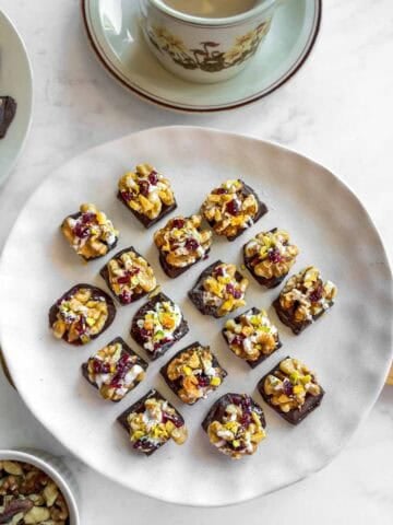 mini chocolate bites with walnuts and dried fruits served with a cup of tea.