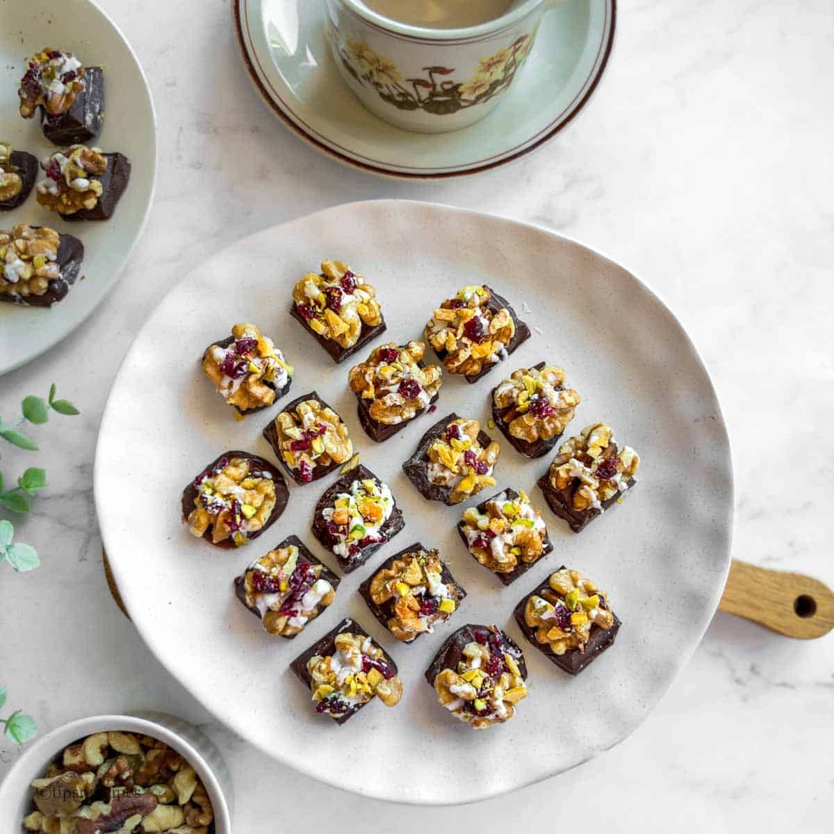 mini chocolate bies with walnuts and dried fruits served with a cup of tea.