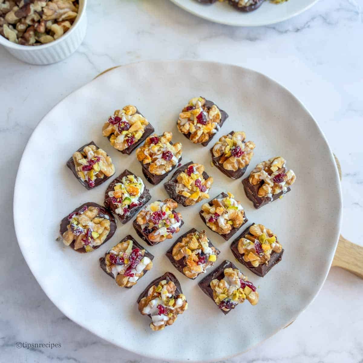 walnut chocolate mini dessert arranged on a plate.